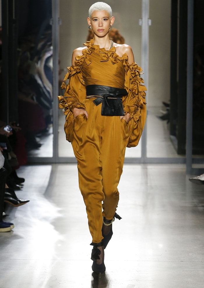 A model presents Zimmermann's Resistance high-waisted silk tapered pants on the runway, highlighting the collection's softly pleated front, relaxed harem-inspired silhouette, and tapered ankle—details that gave Halle Bailey's Teen Choice Awards outfit its fluid yet structured shape