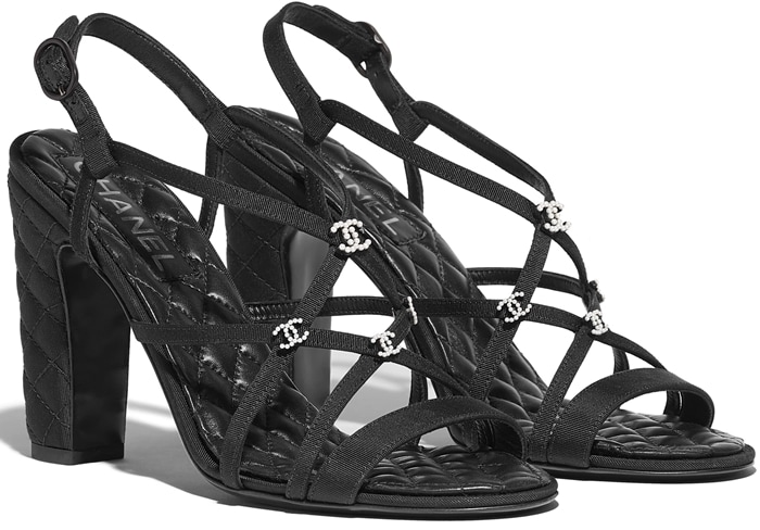 Chanel’s black grosgrain sandals elevate any look with crystal CC accents and the house’s signature quilted block heel