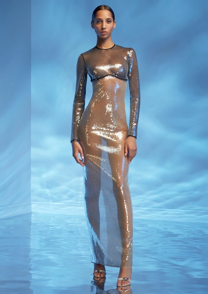 The David Koma Resort 2020 runway version reveals the gown’s sheer sequined construction and metallic strappy platform sandals
