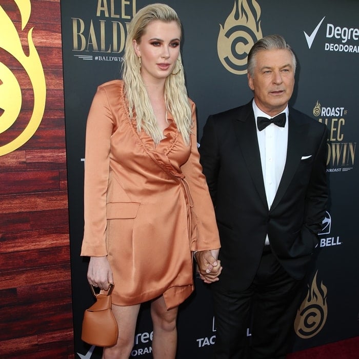 Ireland Baldwin, standing 6ft 0 (182.9 cm) and made even taller by her strappy heels, towers over her father Alec Baldwin as they pose together at the Comedy Central Roast