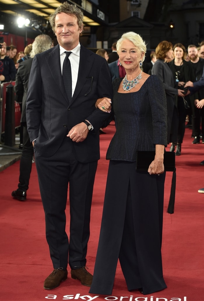 Helen Mirren paired textured midnight-blue tailoring with statement Chopard jewels and a tasseled velvet clutch while posing with co-star Jason Clarke at Curzon Mayfair