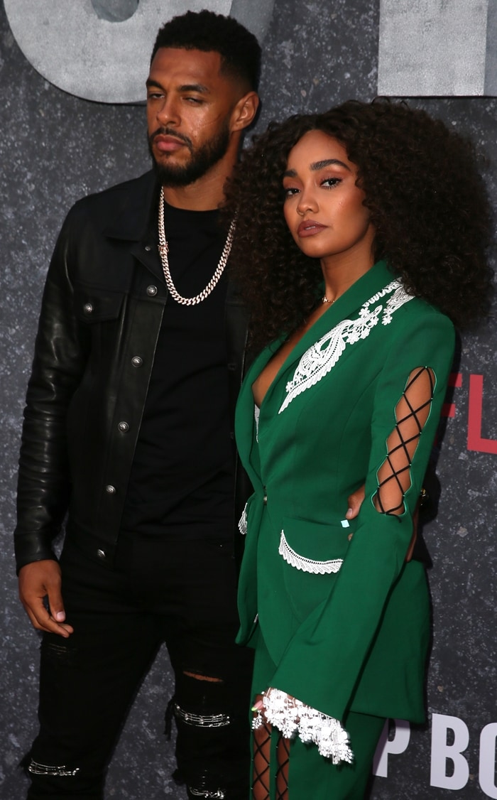 Andre Gray joins Leigh-Anne Pinnock on the red carpet, where the intricate lace and crisscross detailing of her Ana Ljubinković suit contrasts with his all-black look