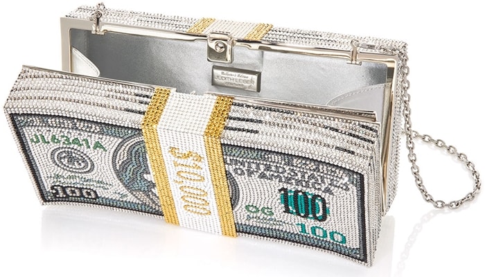 Crafted from silver-tone brass, this novelty piece opens to reveal a fully lined interior for your smaller essentials