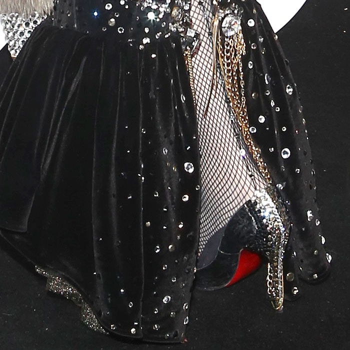 A close look at the hem reveals the gown’s velvety fishtail skirt and shimmering crystal details cascading into her bedazzled Louboutin heels