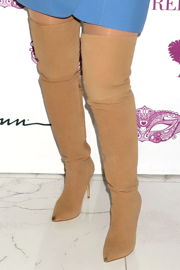 A closer look at the flesh-tone boots reveals a stretch finish and sharply tapered toe, with visible wear at the tips that softens the otherwise sleek, leg-lengthening effect