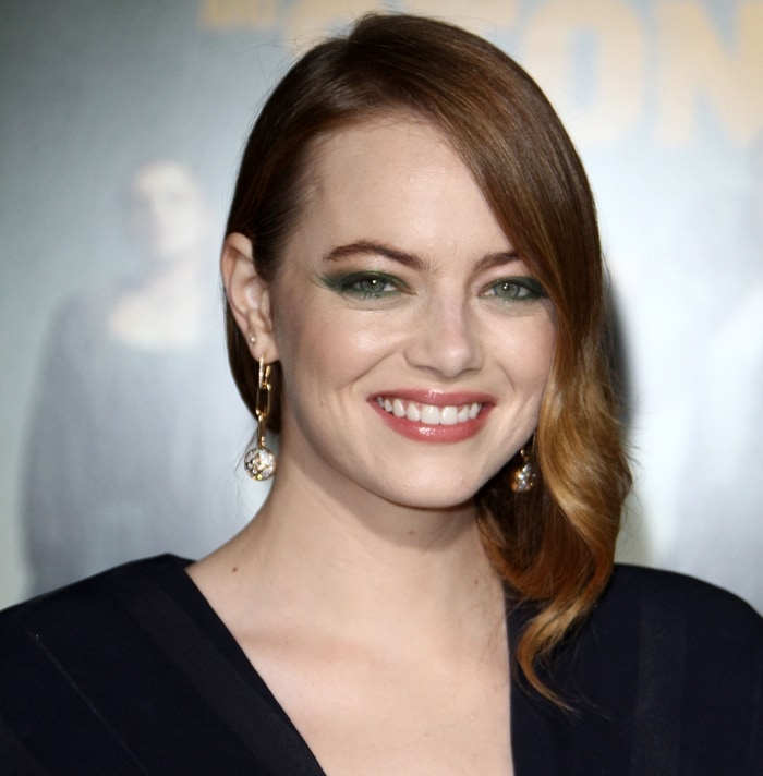 Emma Stone added a playful pop of color to her red carpet beauty look with bold yellow and green eye makeup