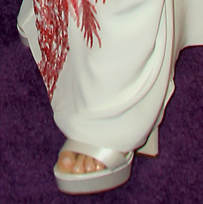 Gwyneth Paltrow completes her look with a pair of white satin platform sandals by Jimmy Choo