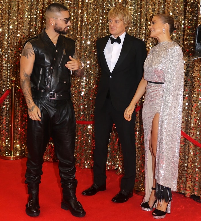 While filming Marry Me in New York City, Jennifer Lopez sparkled in a silver custom Michael Costello gown and the same Tom Ford crystal-embellished velvet platforms she wore to the Governors Awards, alongside co-stars Maluma and Owen Wilson