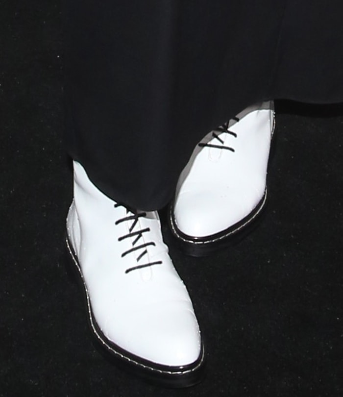 Karlie Kloss completes her edgy black ensemble with white leather “Fara” lace-up combat boots from The Row, featuring welted soles and a subtle one-inch heel