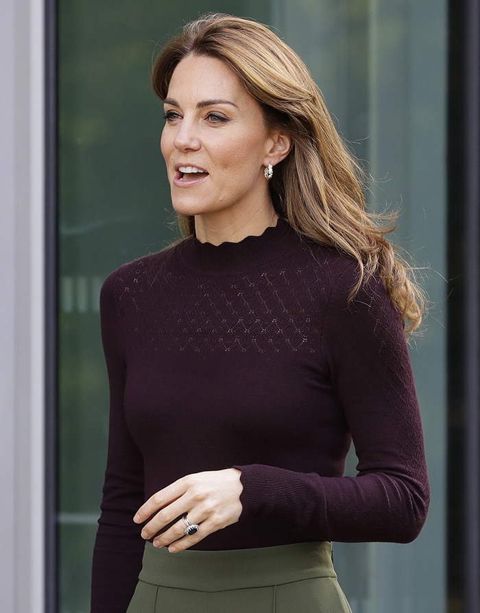 Kate Middleton wears Warehouse’s berry Wave Pointelle High Neck Jumper, detailed with pointelle-knit panels and scalloped edging at the neckline and cuffs