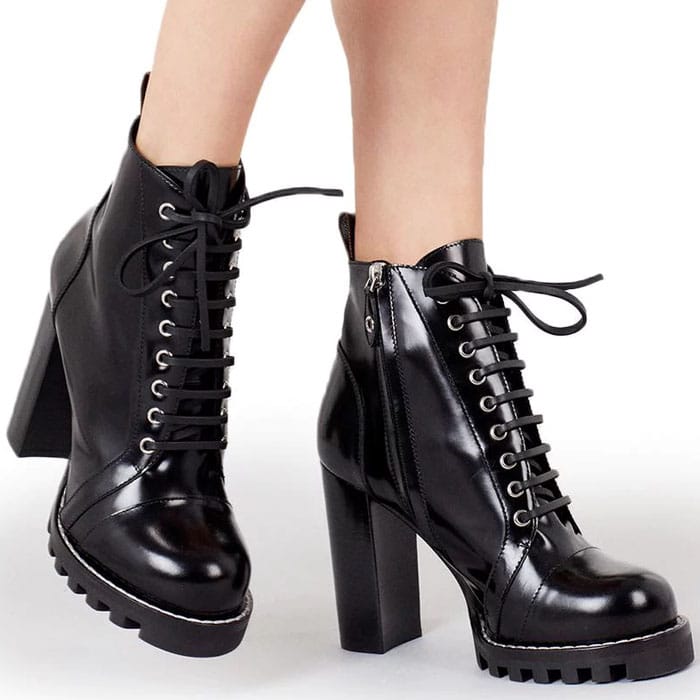 Louis Vuitton ‘Star Trail’ ankle boots in black leather, featuring lace-up fronts, gold-tone eyelets, a chunky block heel, and a rugged lug sole