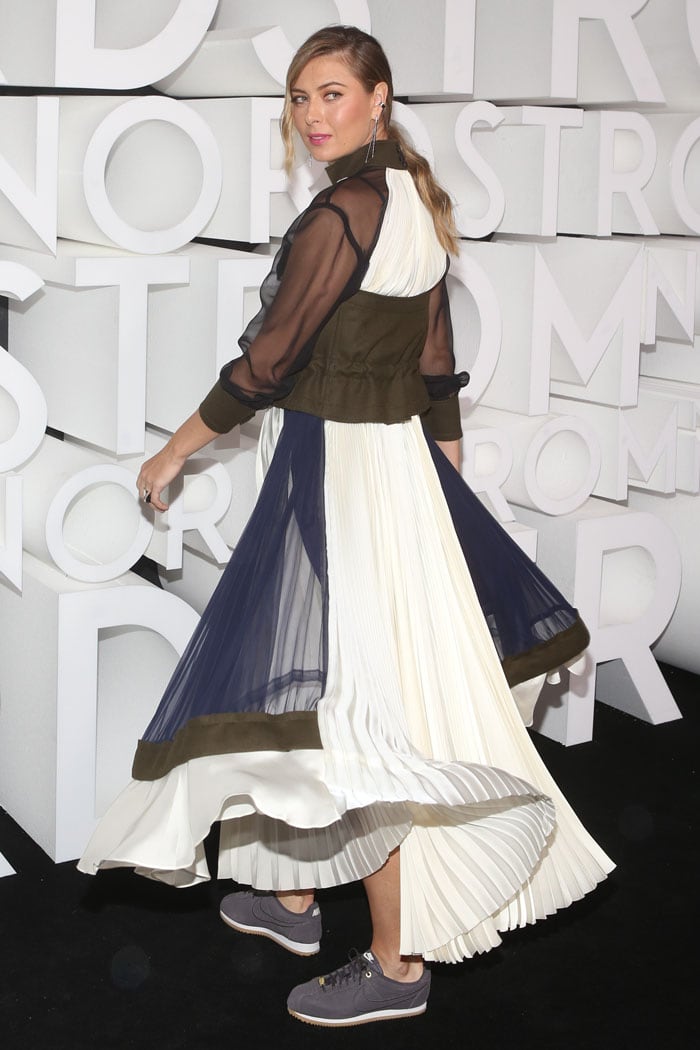 Turning to reveal the fluid motion of her Sacai paneled skirt, Maria Sharapova highlights the contrasting textures that define the hybrid design