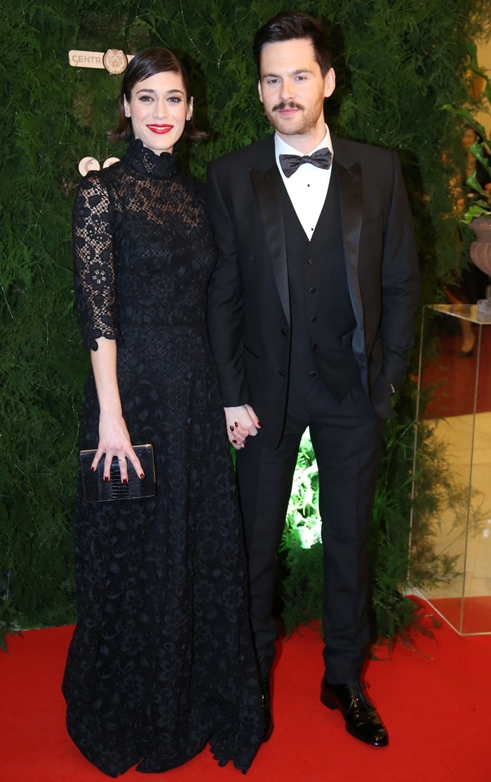 Lizzy Caplan and Tom Riley make a stylish appearance at the Prague Opera Ball, with Lizzy in an elegant black lace Dolce Gabbana gown and Tom in a classic black tuxedo