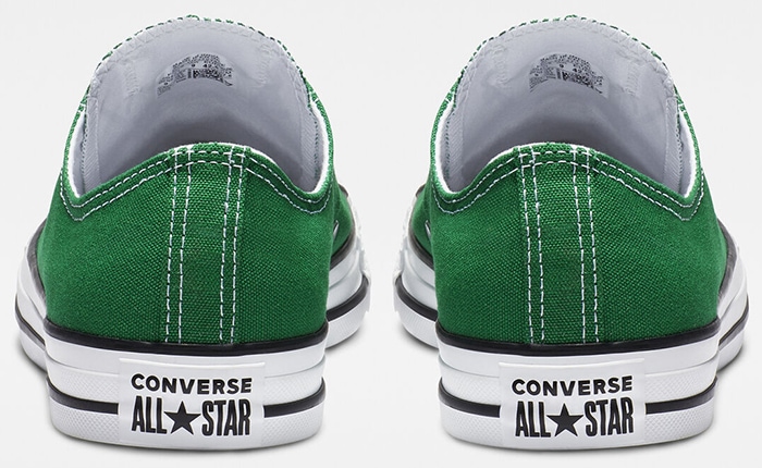 Authentic green Converse Chuck Taylor All Star low-top sneakers featuring the signature white rubber heel patch with black branding