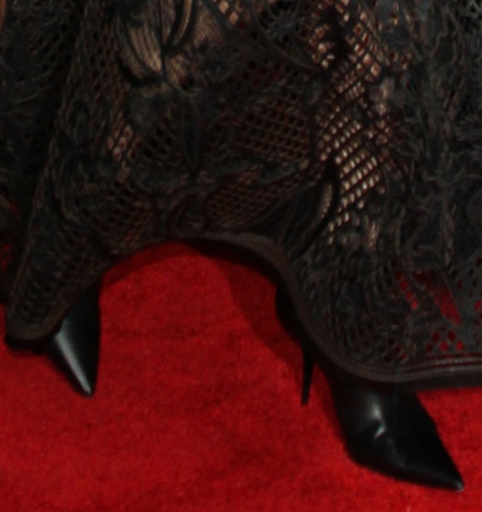 A closer look at Charlize Theron’s sleek black pointed-toe ankle boots peeking out beneath the sheer embroidered hem of her custom Dior leather gown on the red carpet