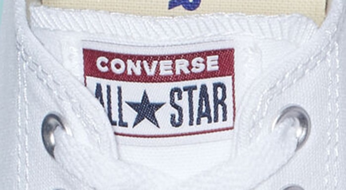 Low-top Converse Chuck Taylor All Star tongue logo patch featuring the classic red, white, and navy color scheme