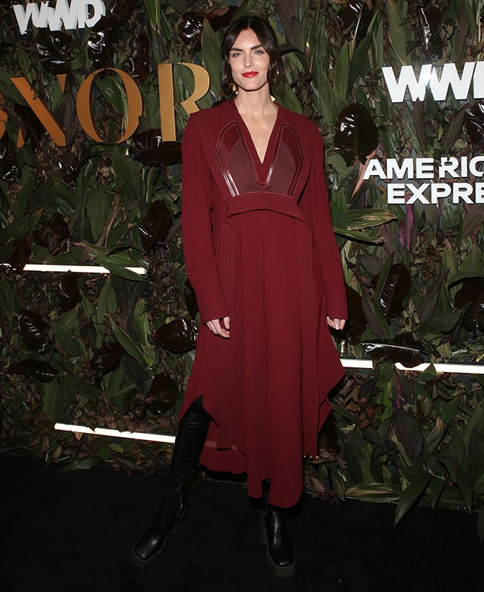 Hilary Rhoda stands out in a deep wine-red Stella McCartney dress featuring recycled patchwork detailing at the 2019 WWD Honors