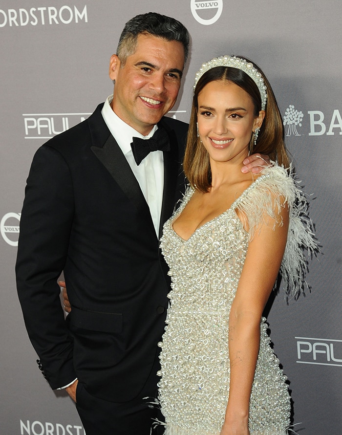Jessica Alba poses alongside her husband Cash Warren as the couple arrive at the Baby2Baby Gala in coordinated black-and-white evening looks