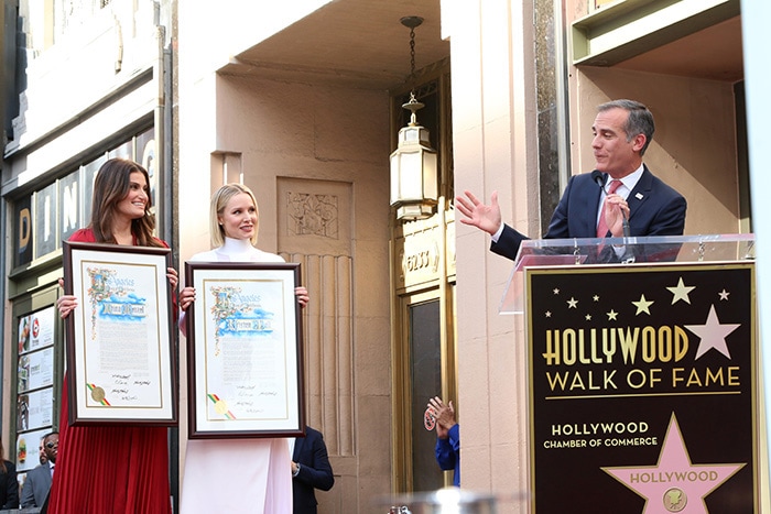 Los Angeles Mayor Eric Garcetti presents certificates to Idina Menzel and Kristen Bell