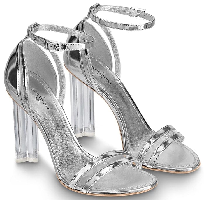 Louis Vuitton’s “Silhouette” sandals pair sleek metallic straps with the house’s instantly recognizable Monogram Flower–shaped block heel, delivering logo-free impact through sculptural design rather than overt branding