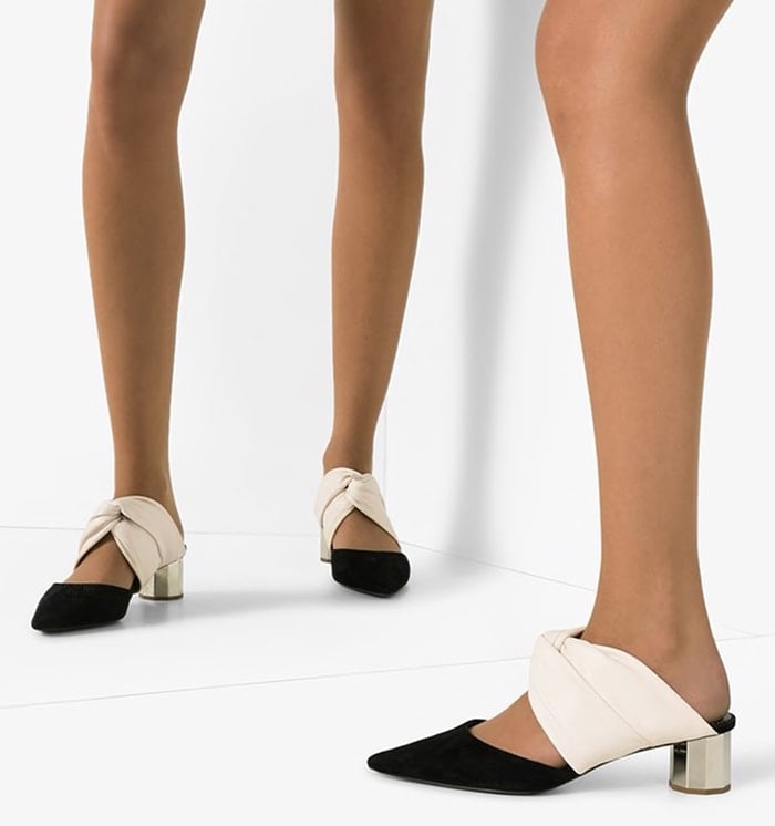 A closer look at the Proenza Schouler Two-Tone 40mm mules reveals the contrasting leather and suede construction, twisted vamp detail, and reflective silver heel