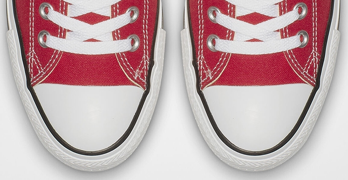 Authentic Converse Chuck Taylor All Star sneakers featuring signature solid white rubber toe caps and clean black piping