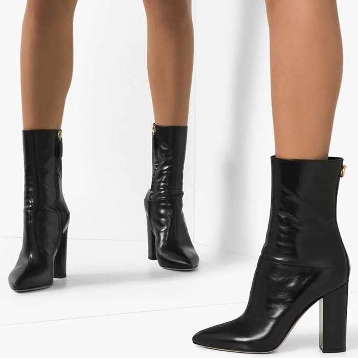 Valentino Garavani Ringstud 100mm ankle boots pair a pointed toe with a substantial block heel and sleek black leather