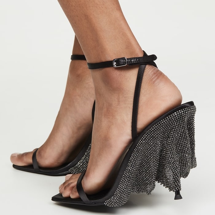 Alexander Wang Blake sandals in black satin feature a modern square toe, delicate ankle strap, and a 105mm wedge-stiletto heel draped in a shimmering crystal chainmail veil, originally retailing for $795