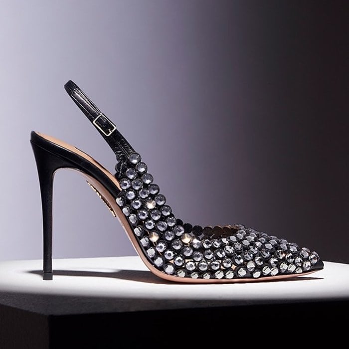 Black crystal-embellished Aquazzura slingbacks showcase the label’s signature mix of sparkle and elegance, pairing faceted stones with a sleek stiletto heel and sculpted pointed-toe shape