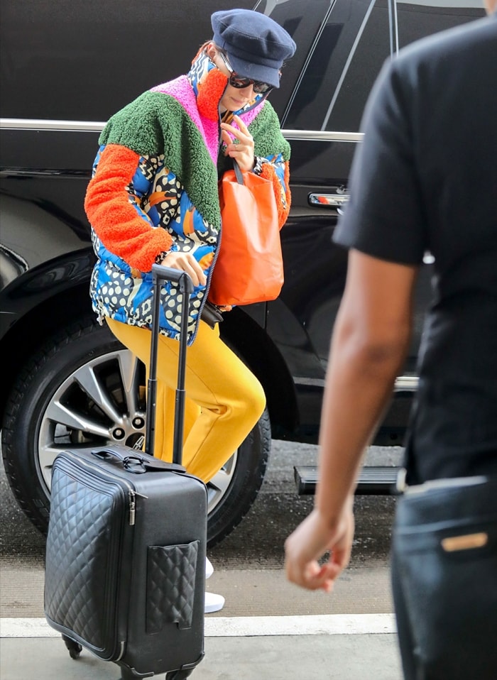 Off-duty, Ridley balances a bold patchwork shearling jacket with relaxed yellow trousers and crisp white low-top Vans sneakers, grounding the playful layers with a clean, skate-inspired base