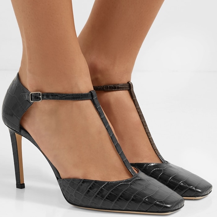 Reese Witherspoon’s Jimmy Choo Lexica pumps in charcoal croc-embossed leather feature a sharp squared toe and elegant T-bar strap, creating a sleek, leg-lengthening silhouette that feels both modern and timeless