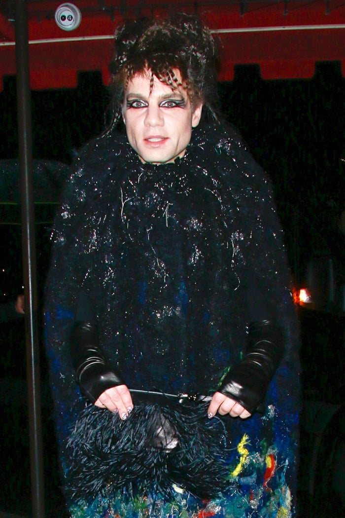 Jordan Roth carried a striking feather-covered purse to the Cats premiere after-party, perfectly complementing his avant-garde, textured couture ensemble and bold feline-inspired makeup