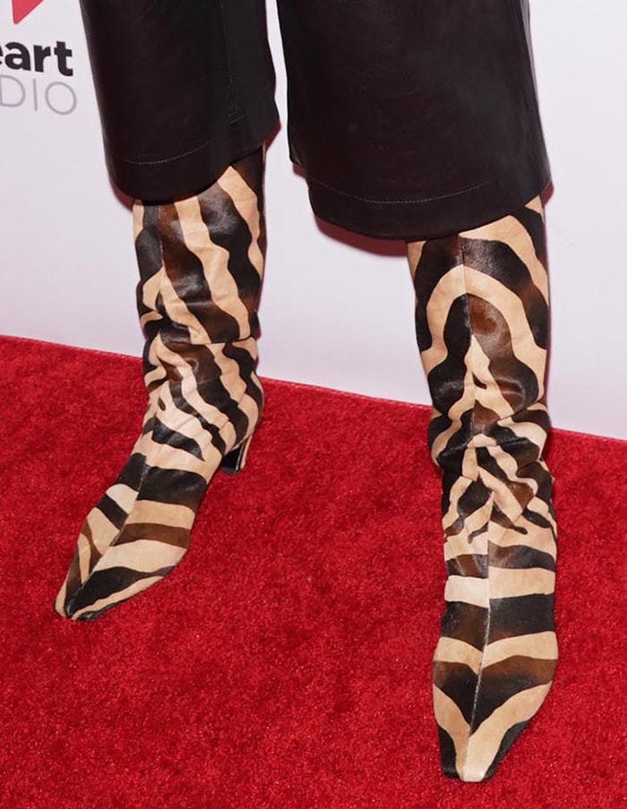 Katie Holmes’ Khaite zebra-print boots combined square toes, low kitten heels, and slouched calf hair uppers, turning animal print into the defining texture of the outfit
