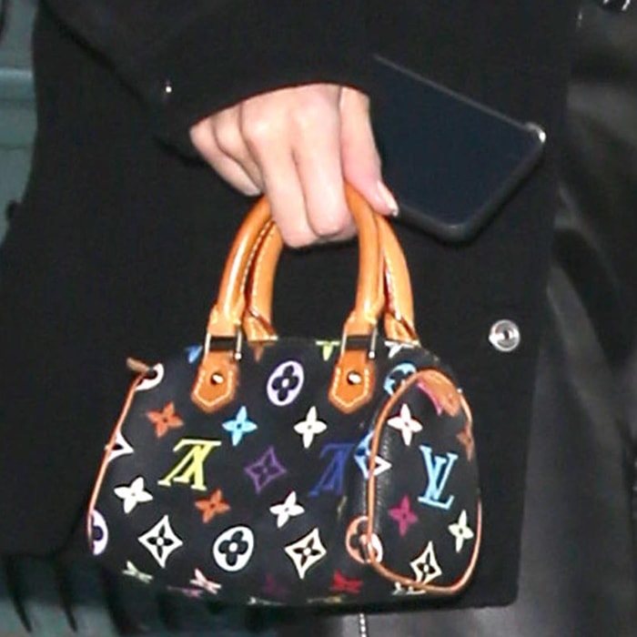 Kendall Jenner’s Mini HL Speedy features Takashi Murakami’s colorful Monogram Multicolore print on black canvas with Louis Vuitton’s signature natural leather handles and trim