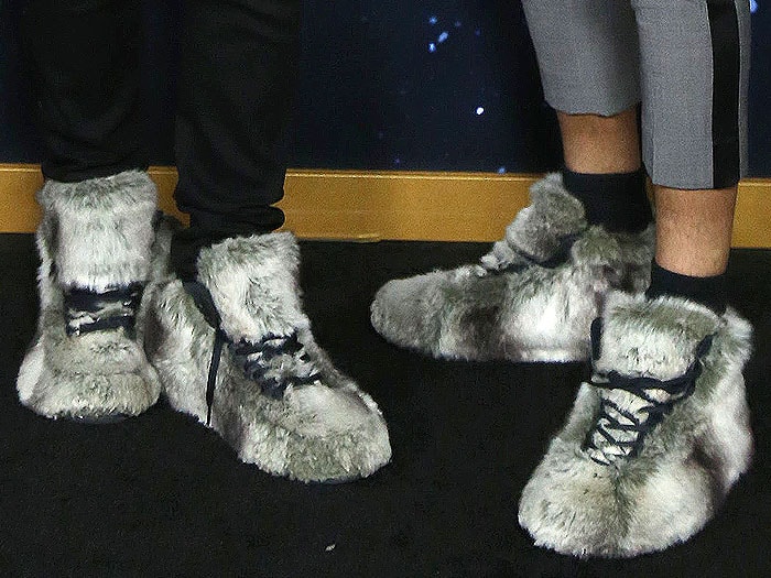 Les Twins showcase bold, feline-inspired style at the Cats premiere with matching gray fur-covered sneakers and untied laces for an edgy, playful touch