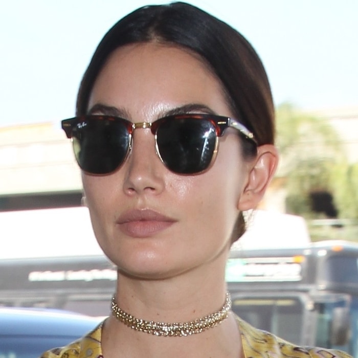 A model showcases retro-inspired Ray-Ban Clubmaster Classic sunglasses, underscoring the enduring appeal of the brand’s timeless browline design