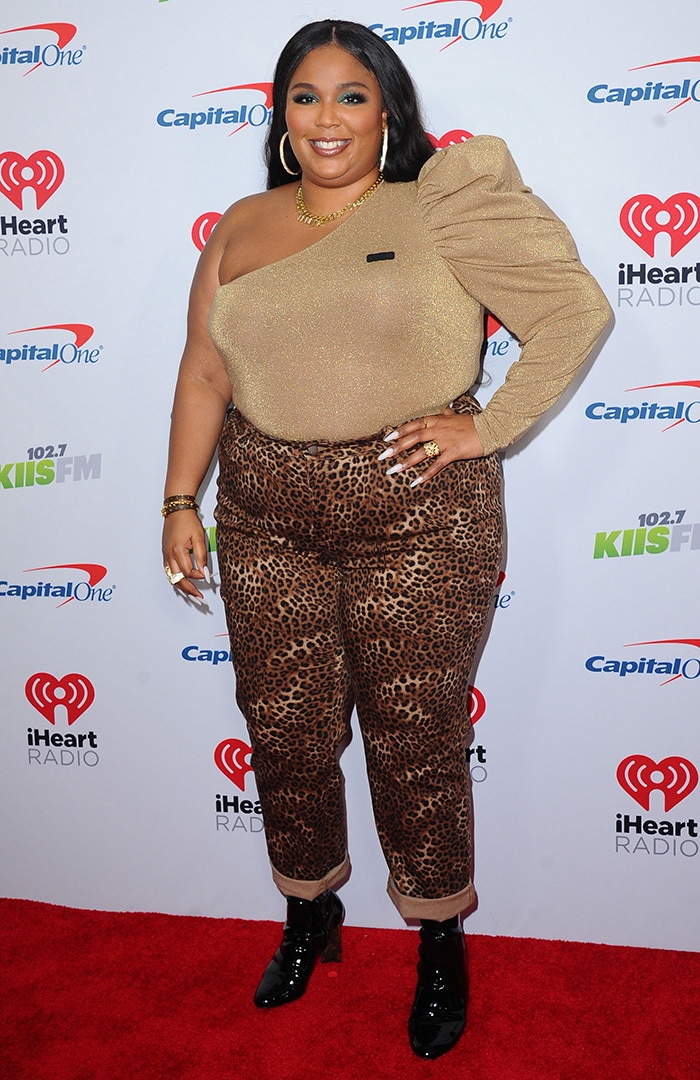 Lizzo wears leopard-print trousers with an asymmetrical black top and black patent platform ankle boots at the 2019 KIIS FM Jingle Ball