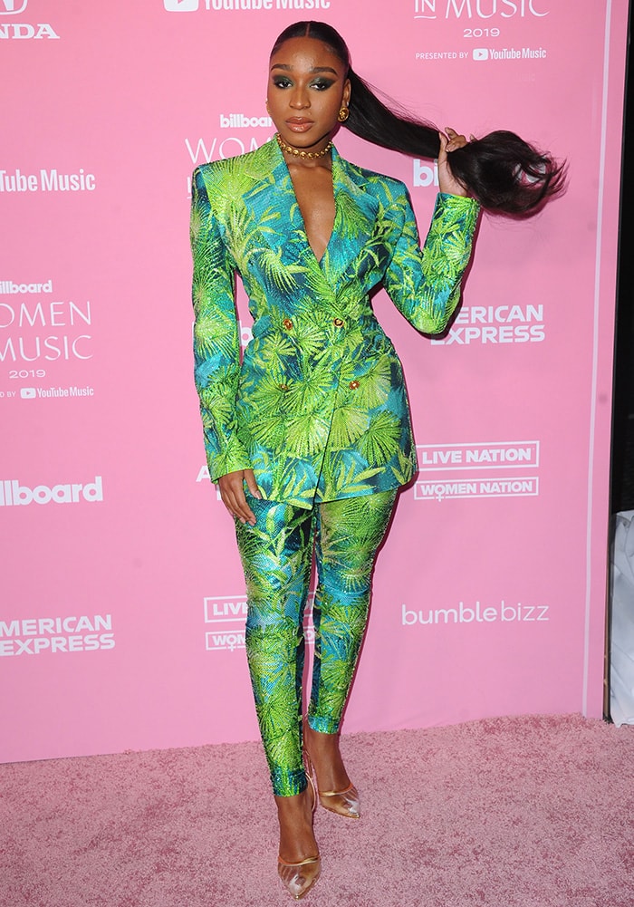 Styled by Kollin Carter, Normani gives Versace’s runway tailoring a more fitted interpretation by pairing the plunging jungle-print blazer with matching high-waisted leggings