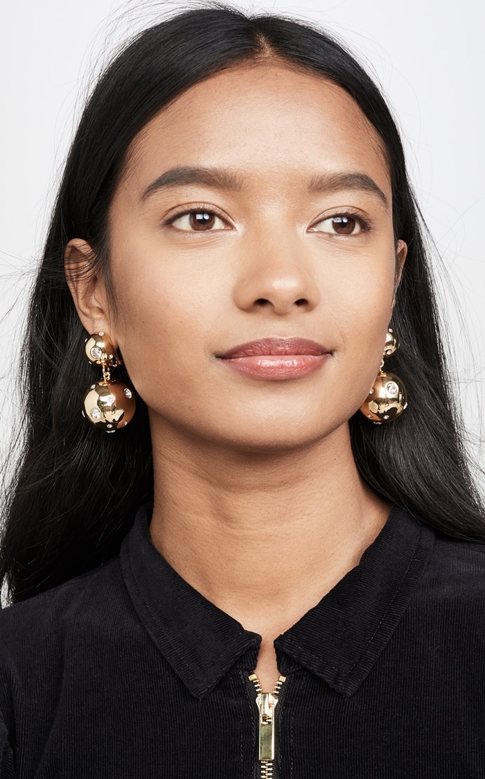 Featuring a unique, asymmetrical arrangement of brilliant Swarovski crystals, these Rebecca De Ravenel statement earrings add an eye-catching touch to any look.