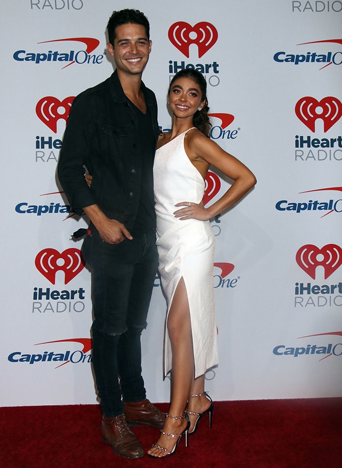 Sarah Hyland wearing a Manning Cartell dress and Sophia Webster sandals with Wells Adams at the 2018 iHeartRadio Music Festival