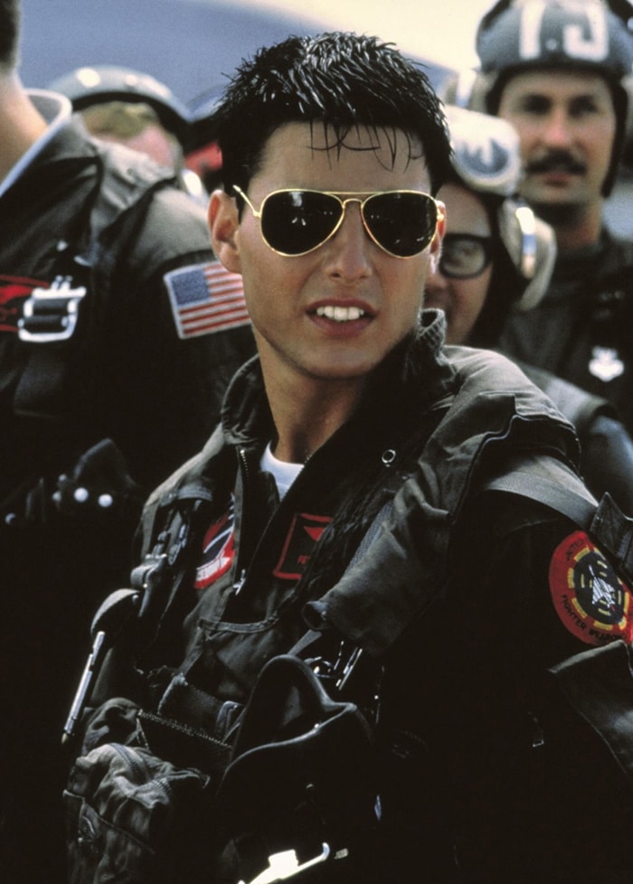 Tom Cruise cements Ray-Ban Aviator Classic (model 3025) as a pop-culture icon, wearing the gold-framed, green-lens sunglasses as U.S. Navy pilot LT Pete “Maverick” Mitchell in Tony Scott’s 1986 action classic Top Gun