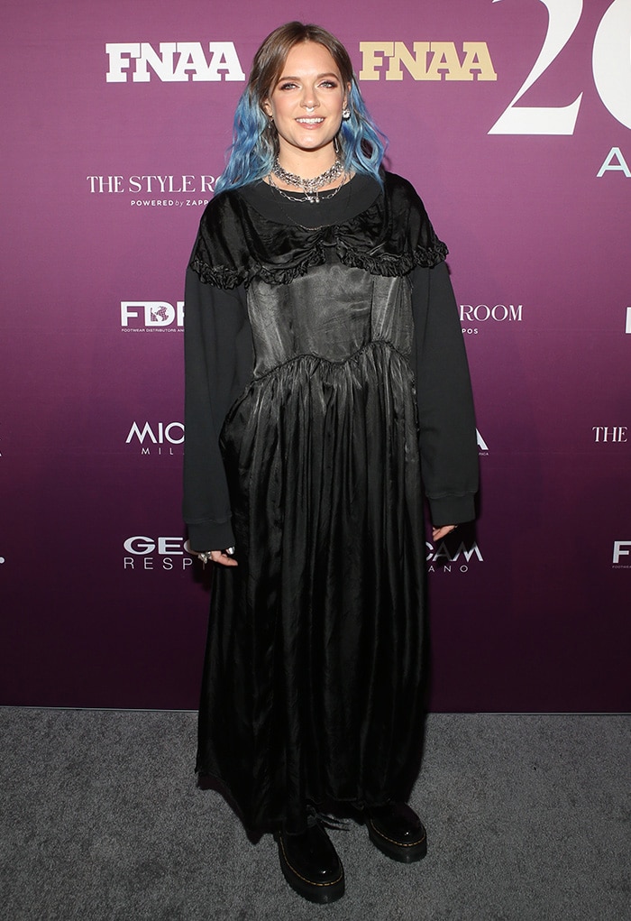 Tove Lo embraces gothic-chic vibes in a mixed-media black dress paired with edgy Dr. Martens 'Holly' shoes and layered silver chains
