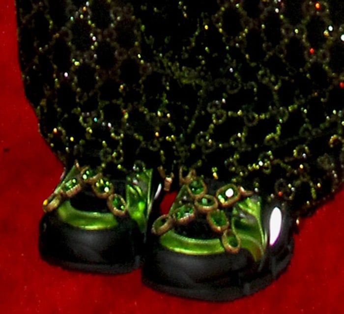 Billie Eilish grounds her oversized Gucci ensemble with crystal-embellished Flashtrek sneakers, featuring a hiking-inspired silhouette, metallic green panels, and chunky rubber soles that add weight, height, and attitude to her red carpet look at the 2020 Grammys