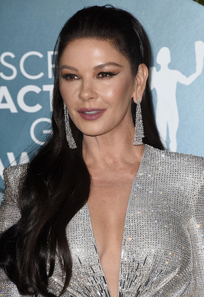 Diamond chandelier earrings and sleek half-up hair complemented Catherine Zeta-Jones' crystal-encrusted Julien Macdonald gown, keeping the focus on the dress's dramatic starburst bodice