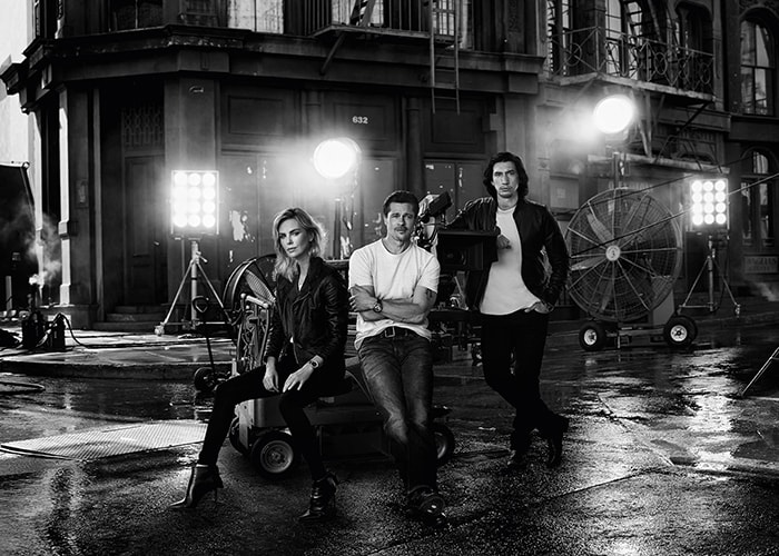 Charlize Theron, Brad Pitt, and Adam Driver pose in a moody black-and-white city set for Breitling’s Cinema Squad campaign, blending classic Hollywood cool with modern cinematic edge