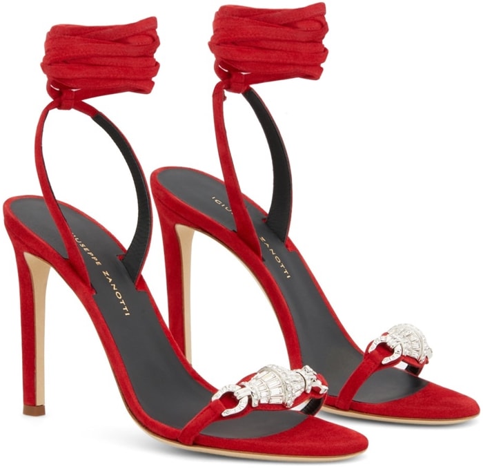 Giuseppe Zanotti’s Spring/Summer 2020 Thais sandals combine red suede, 105mm stiletto heels, wraparound ankle ties, and vintage-inspired crystal ornaments across the toe straps
