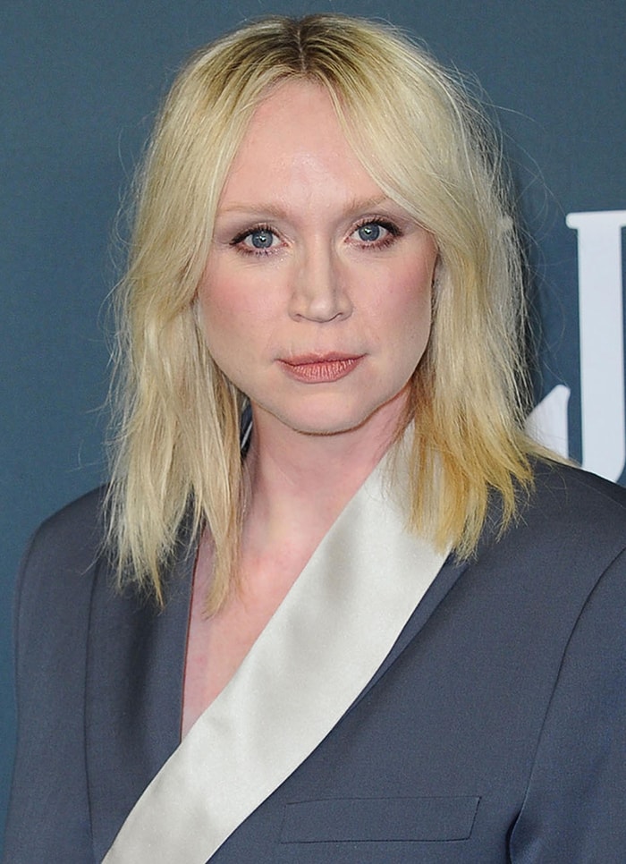 Gwendoline Christie keeps her beauty look understated with softly textured blonde hair, barely-there makeup, and a minimalist Dior Fine Jewelry ring that lets the tailored suit remain the focal point
