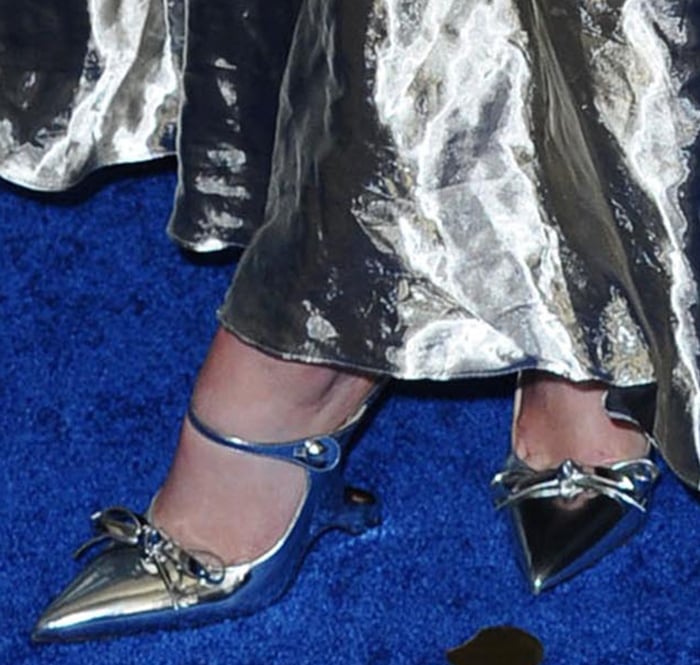 Joey King teams her silver dress with metallic silver Prada mules
