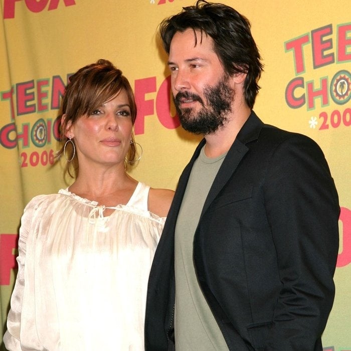 Sandra Bullock kept it effortlessly chic in a white peasant blouse with hoop earrings, while Keanu Reeves opted for a rugged look in a muted T-shirt and black blazer at the 2006 Teen Choice Awards