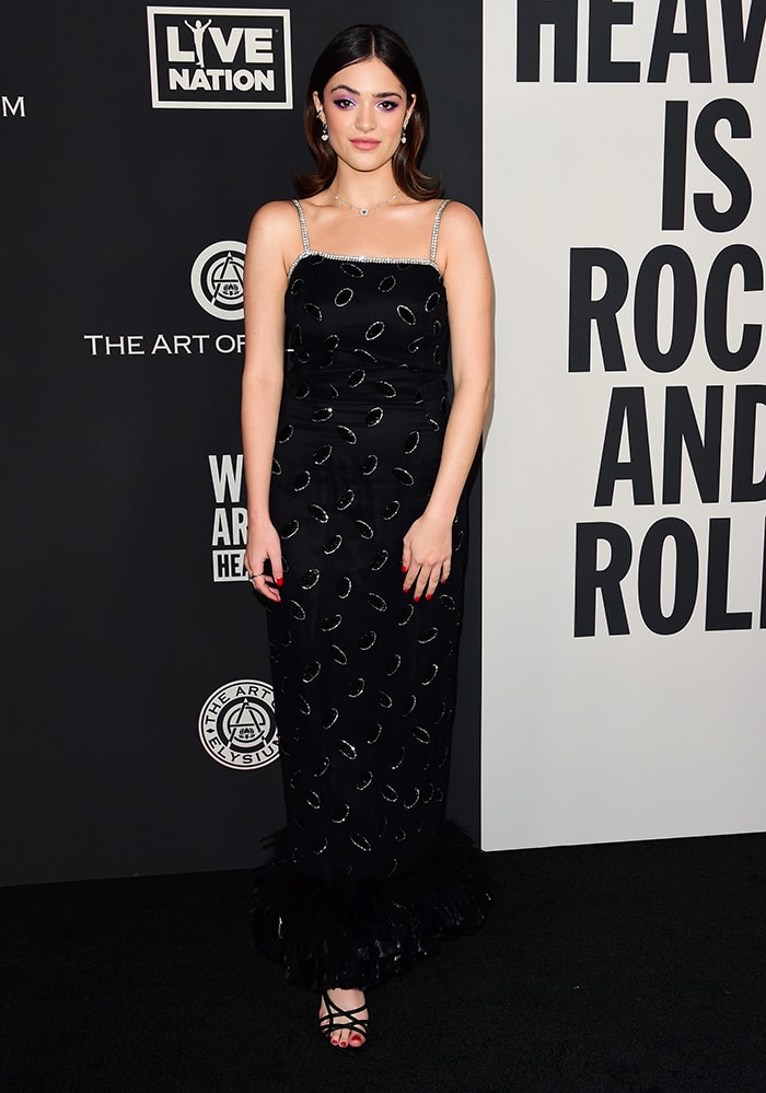 Luna Blaise stuns in a vintage Norma Kamali dress with crystal embellishments and a feathered hem, completing her glamorous look with strappy Alevi Milano sandals